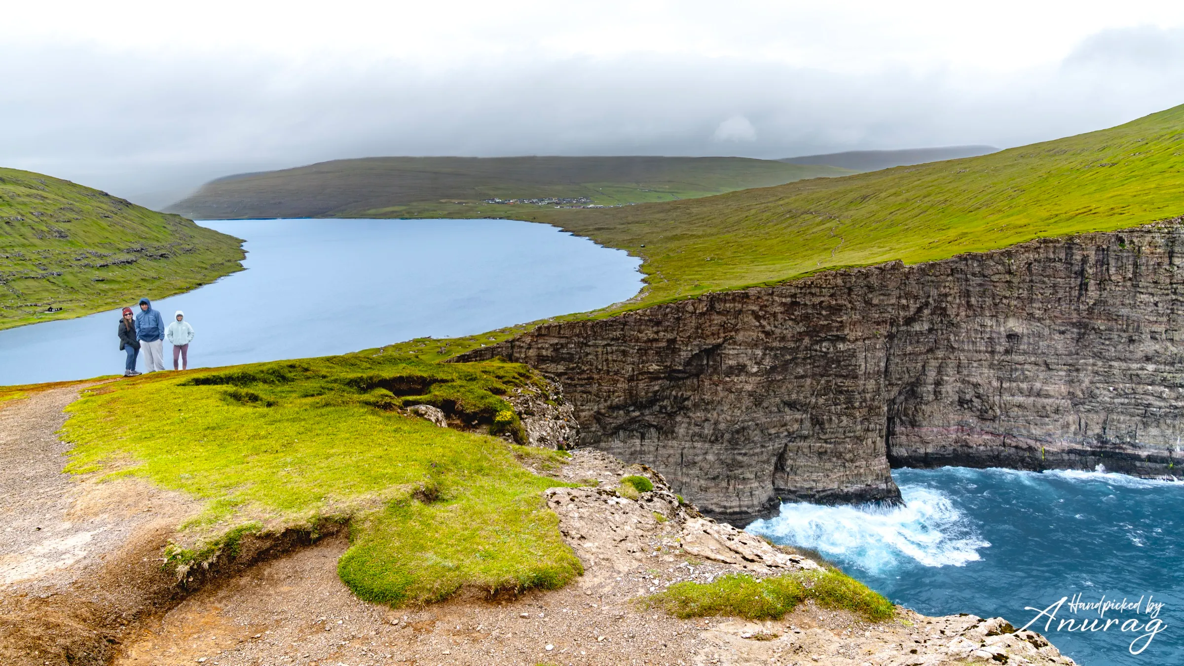 Lake Leitisvatn appearing to float above the Atlantic beside the sheer cliffs of Vágar