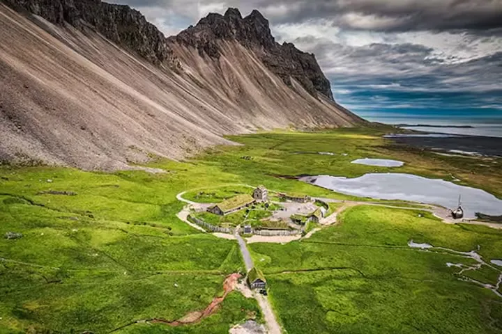 The turf-roofed Viking village on the Stokksnes peninsula beneath the dramatic Vestrahorn mountain, near the Viking Café, Southeast Iceland